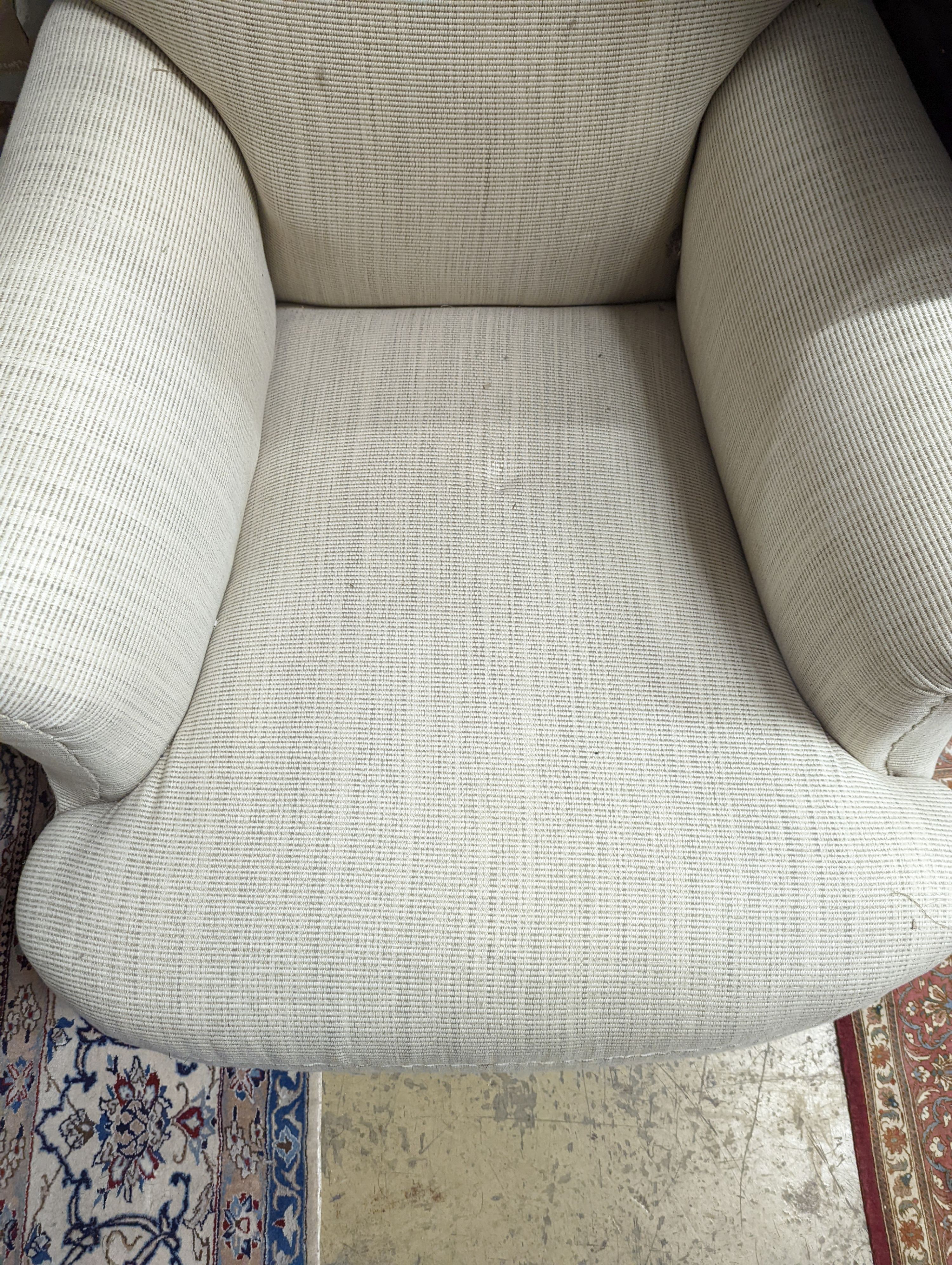 A late Victorian Howard style upholstered armchair, width 81cm, depth 82cm, height 92cm